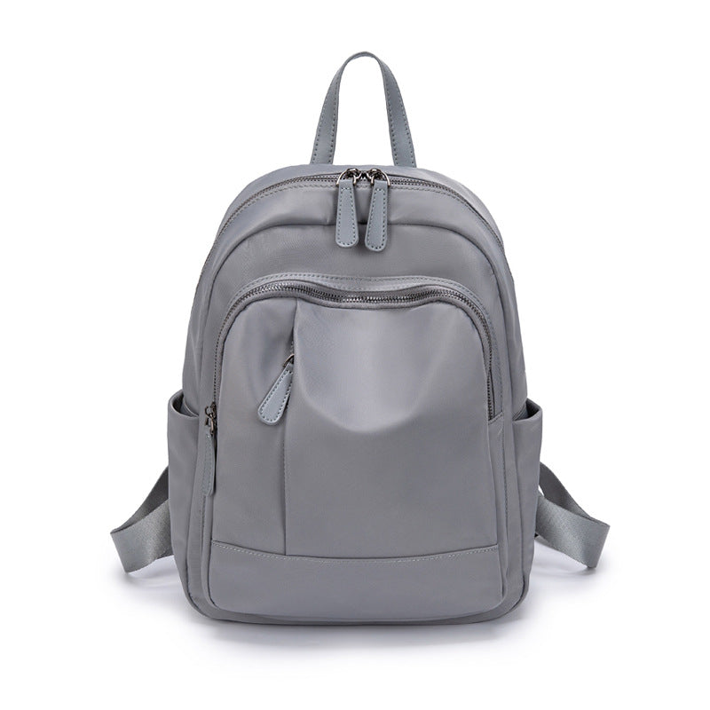 2023 New Simple School Bag Female College Student Niche Non-Contrast Model Junior High School Student Large Capacity Oxford Cloth Backpack